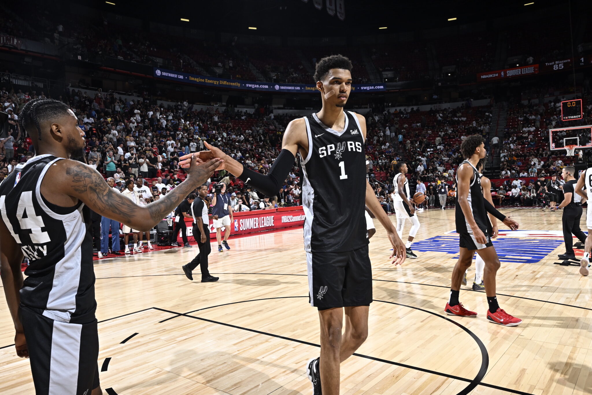 LAS VEGAS, NV - JULY 9: Victor Wembanyama #1 high fives teammate Blake Wesley #14 of the San Antonio Spurs after the game during the 2023 NBA Las Vegas Summer League on July 9, 2023 at the Thomas & Mack Center in Las Vegas, Nevada. NOTE TO USER: User expressly acknowledges and agrees that, by downloading and or using this photograph, User is consenting to the terms and conditions of the Getty Images License Agreement. Mandatory Copyright Notice: Copyright 2023 NBAE (Photo by David Dow/NBAE via Getty Images)